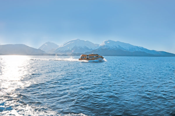 PALFINGER tender boat navigating through cold waters with snow-covered mountains in the background