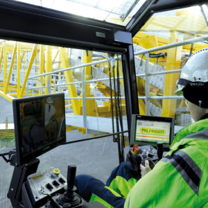 Engineer conducting tests from the crane operator cabin at the production site
