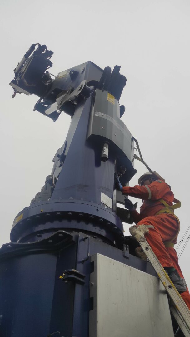 Marine crane inspected by a PALFINGER service technician