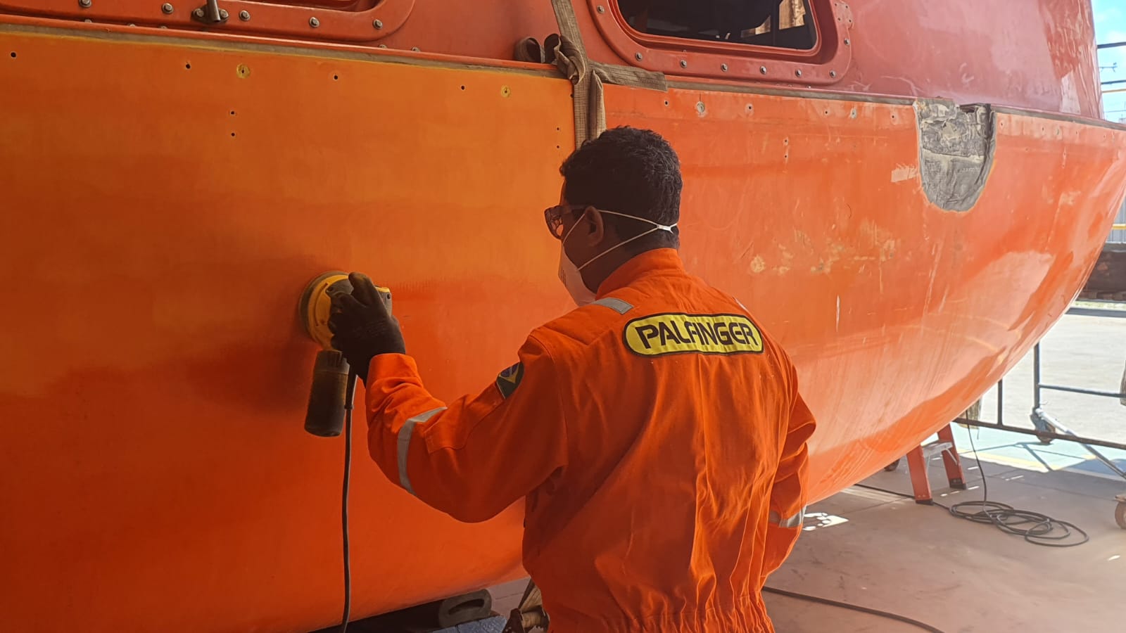 Lifeboat refurbished by a PALFINGER service technician in a workshop